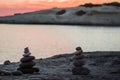 Pyramid stones balance on the sand of the beach. The object is in focus,sunset view. Royalty Free Stock Photo