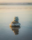 Pyramid of stones on the beach at sunset. Tranquil scene, relaxation, seaside vacation, meditation concept