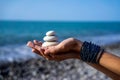 Pyramid of stones on female palm Royalty Free Stock Photo