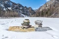Pyramid of stones on a frozen river Royalty Free Stock Photo