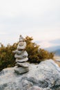 Pyramid of stones on a large stone at the top of a mountain Royalty Free Stock Photo