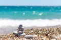 Pyramid of stones. Obo from pebbles. Stone tower on the beach against the blue sea. Balance, peace of mind, stones form a pyramid Royalty Free Stock Photo