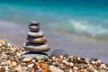 Pyramid of stones on pebble beach near the ocean. Obo from pebbles. Stone tower on the beach. Balance, peace of mind Royalty Free Stock Photo