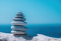 Pyramid stones on the seashore on a sunny day on the blue sea background. Happy holidays. Pebble beach, calm sea, travel Royalty Free Stock Photo