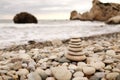 Pyramid stones on the seashore on a sunny day on the blue sea background. Happy holidays. Pebble beach, calm sea, travel Royalty Free Stock Photo