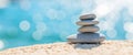 Pyramid stones on the seashore on a sunny day on the blue sea background. Happy holidays. Pebble beach, calm sea, travel Royalty Free Stock Photo