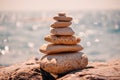 Pyramid stones on the seashore on a sunny day on the blue sea background. Happy holidays. Pebble beach, calm sea, travel Royalty Free Stock Photo