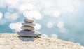 Pyramid stones on the seashore on a sunny day on the blue sea background. Happy holidays. Pebble beach, calm sea, travel Royalty Free Stock Photo