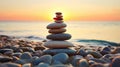 Pyramid stones on the seashore with warm sunset on the sea background. Happy holidays. Pebble beach, calm sea, travel destination