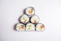 A pyramid of sushi on a white background. Dish of Asian cuisine