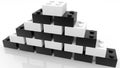 Pyramid of toy bricks in white and black colors on white Royalty Free Stock Photo