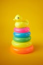 Pyramid toy. Circle Plastic Colorful. The newborn children bathing fun moments get baby and mother. Toys for Children on yellow ba