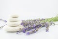 Pyramid of white stones and bouquet of lavenders on white background.