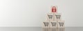Pyramid of wooden blocks with shopping cart icons and lock icon on top, secure, safe online shopping concept Royalty Free Stock Photo