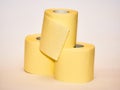 pyramid of yellow toilet paper isolated over white background Royalty Free Stock Photo