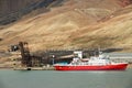 Ship unloads at the pier of the abandoned Russian arctic settlement Pyramiden, Norway.