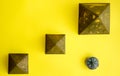 Pyramids and compass on yellow background Royalty Free Stock Photo
