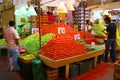 Pyramids of fresh tomatoes, indoor market,