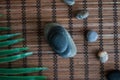 Pyramids of gray zen stones with green leaves and Buddha statue. Concept of harmony, balance and meditation, spa, massage, relax Royalty Free Stock Photo