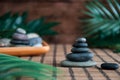 Pyramids of gray zen stones with green leaves. Concept of harmony, balance and meditation, spa, massage, relax Royalty Free Stock Photo