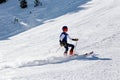 PYRENEES, ANDORRA - FEBRUARY 16, 2019: A boy skiing in slalom uniform on a mountainside makes a sharp turn