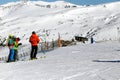 PYRENEES, ANDORRA - FEBRUARY 13, 2019: Group skiers stand at the beginning of the ski slope and look down.