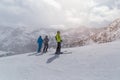 PYRENEES, ANDORRA - FEBRUARY 11, 2019: Three unknown skiers in red jackets on a mountainside.