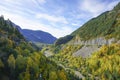 the Pyrenees unveil verdant valleys, a tapestry of rich greens undulating under a vast sky