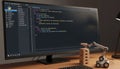 Python code monitor toy robot blocks low-key lighting wooden desk Royalty Free Stock Photo