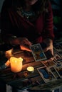 A pythoness shows tarot cards on a wooden table