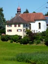 Church with parsonage in green surroundings
