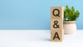 Q AND A - acronym from wooden blocks with letters, questions and answers. concept on grey background. copy space Royalty Free Stock Photo