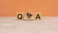 Q and A - acronym from wooden blocks with letters, questions and answers concept. orange background. copy space Royalty Free Stock Photo