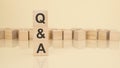 Q and A - acronym from wooden blocks with letters, questions and answers concept on yellow background. copy space Royalty Free Stock Photo