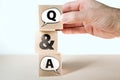 Q and A question and answers concept with speech bubbles on wooden blocks