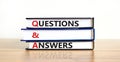 Q and A, questions and answers symbol. Concept words `Q and A questions and answers` on books on a beautiful wooden table, white Royalty Free Stock Photo