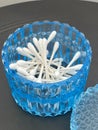 Q-tips in a blue glass vanity container jar, q-tips for makeup application, ear cleaning Royalty Free Stock Photo