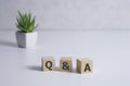 Q A word with paper note on white wood table backgrounds Royalty Free Stock Photo