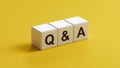 QA Question answer. The wooden cubes form the word QA Question answer. Business The concept of QA Question answer Royalty Free Stock Photo