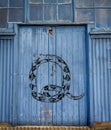 QAnon snake graffiti on old warehouse door, conspiracy theory secret society concept Royalty Free Stock Photo