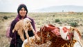 Qashqai nomadic woman holding a baby goat, Shiraz, Iran