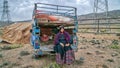 Qashqai nomadic woman sitting at the back of her old car, Iran
