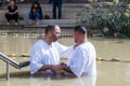 Two pilgrims make an oath during the ceremony of baptism on the Baptismal Site of Jesus Christ - Qasr el Yahud in Israel Royalty Free Stock Photo