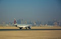 Qatar Aircraft Airbus 320 on runway going to take off in front of Doha skyscrapers