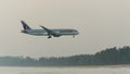 Qatar airways airplane landing at phuket airport in hazy day Royalty Free Stock Photo