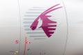 Qatar Airways symbol on airplane. Qatar Airways purple sign on engine. Aircraft industry. Travel business concept.