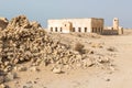 Qatar. The Desert At Coast Of Persian Gulf. Abandoned Mosque With Minaret. Deserted Village. Pile Of Stones