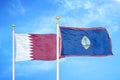 Qatar and Guam two flags on flagpoles and blue cloudy sky