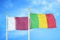 Qatar and Mali two flags on flagpoles and blue cloudy sky