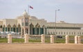 Qatar national flag flying over Amiri Diwan Parliament Building and clock tower Royalty Free Stock Photo